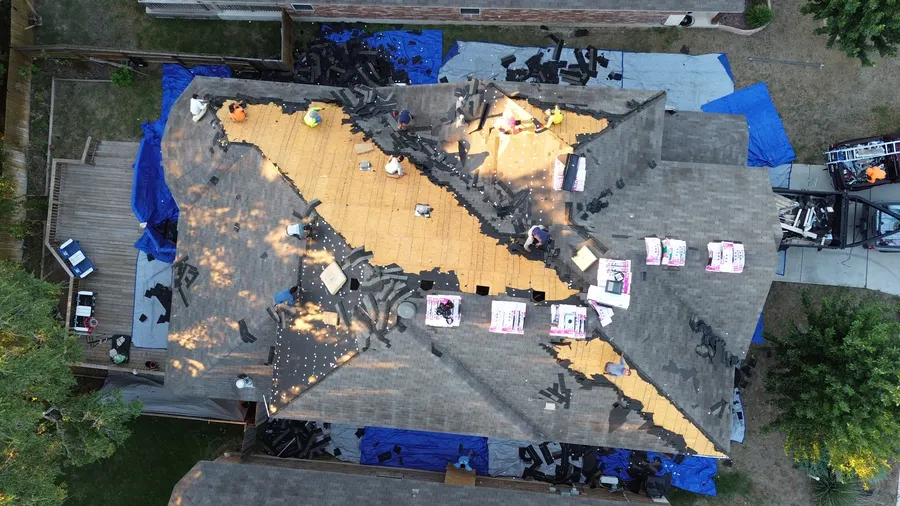 Tear-off with ground tarps protecting the yard by DNA Restoration & Construction
